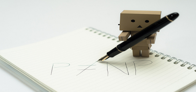 Toy robot writing its signature on a paper notepad, representing the concept of digital signatures and PKCS 7 